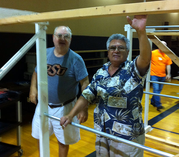 Lecturer Jim Russell and Grand Knight Frank Salazar inspecting the clothes racks.