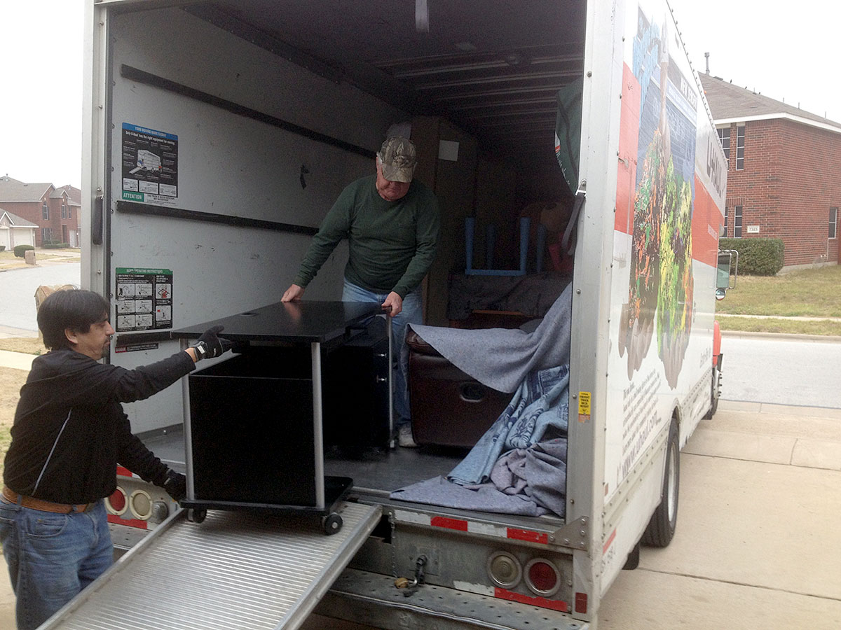 Jorge Ruiz and Allen Reitmeier unloading a desk off the 26 foot U-haul truck.