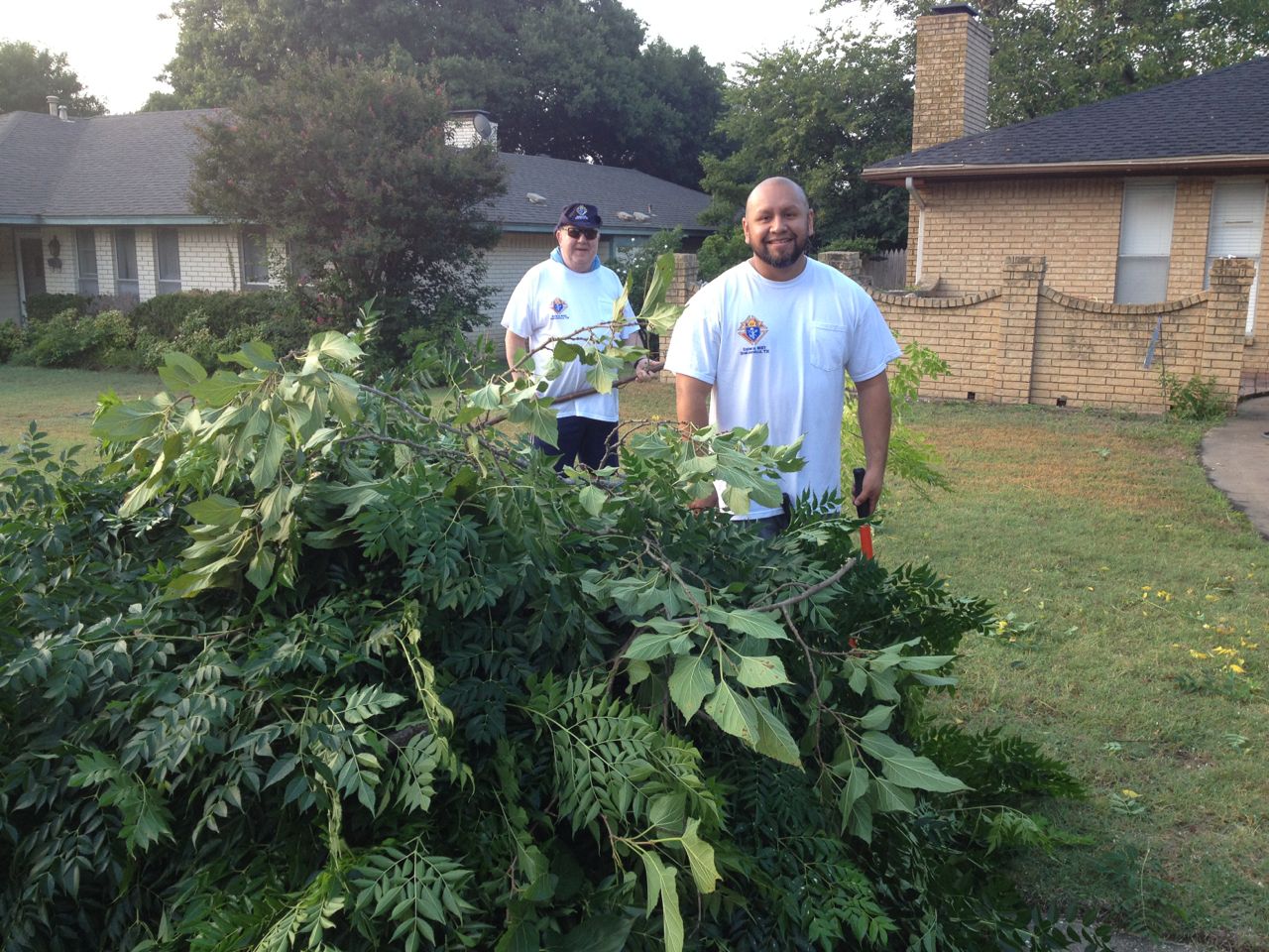 Jim Stavinoha and Abel Lugo cutting Yolanda's trees