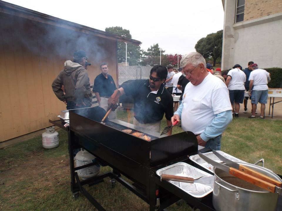 Allen Reitmeier and Jorge Ruiz grilling burgers at Holy Trinity Seminary University Dallas.