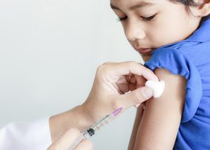 Girl and vaccine syringe
